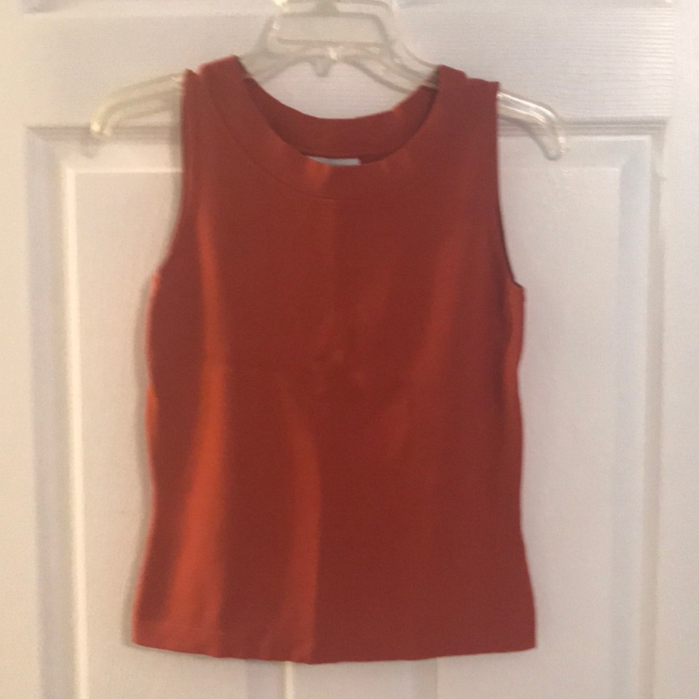 Burnt orange colored shirt.